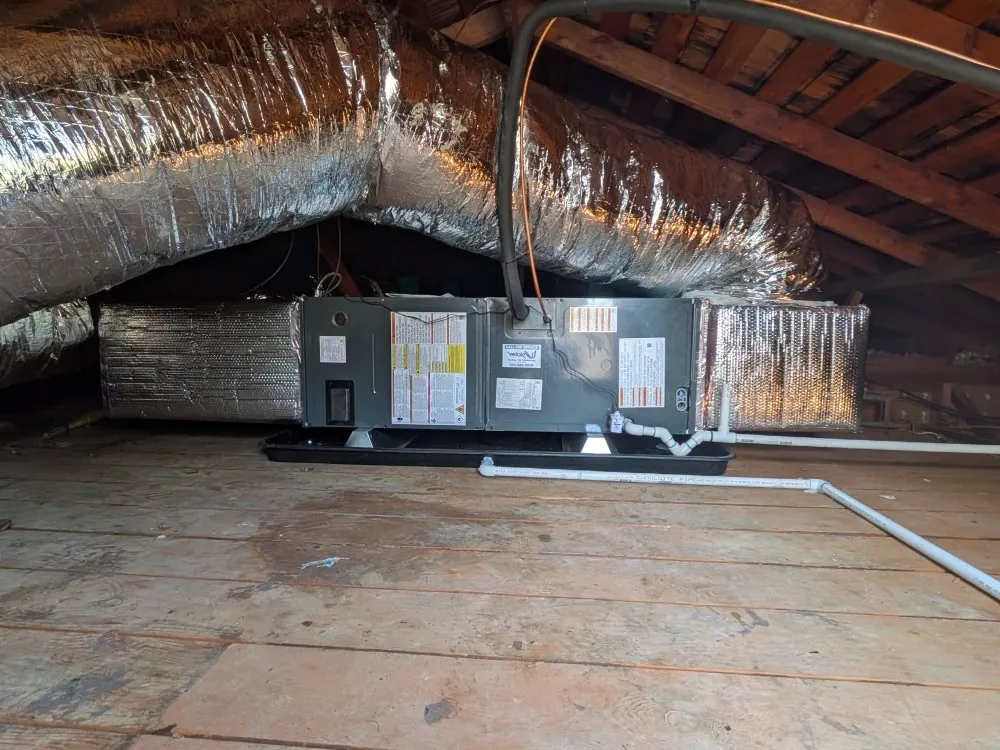 An air handler installed in an attic.