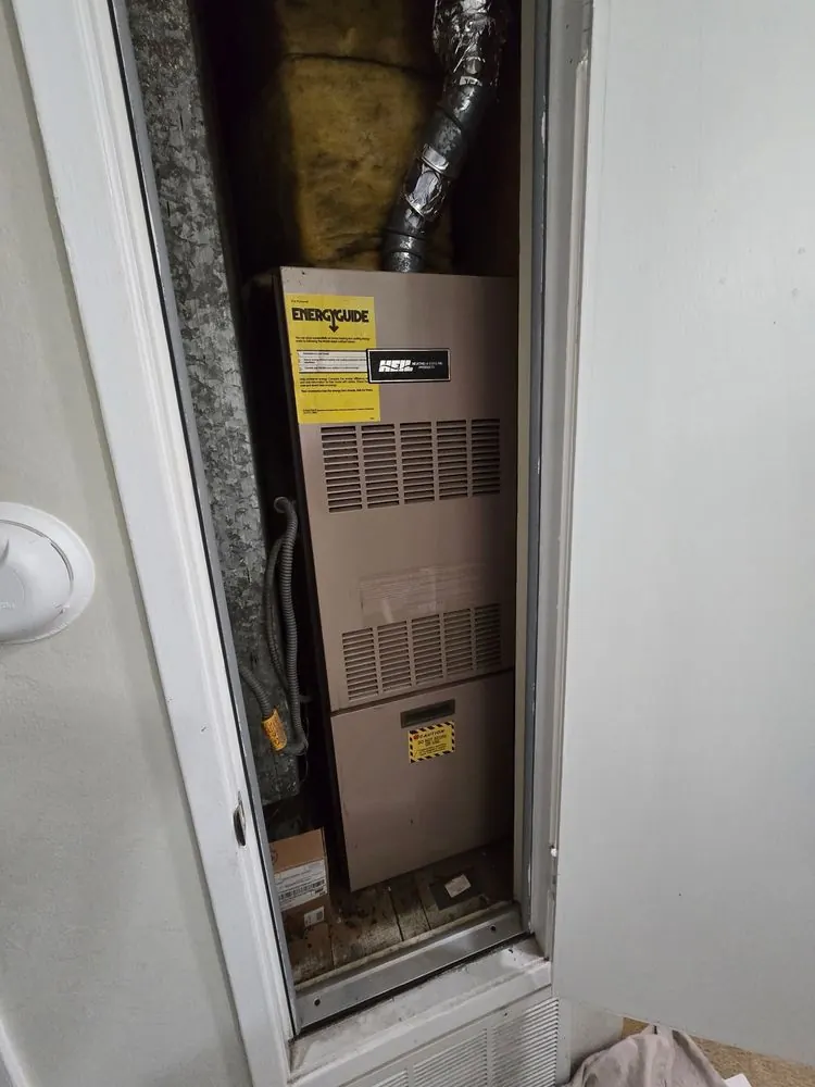 A furnace installed in a hall closet.