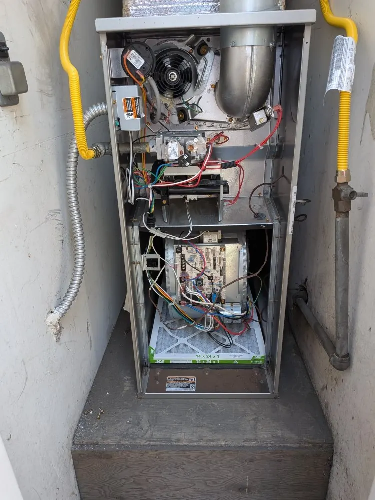 A furnace with the panel open during a repair.