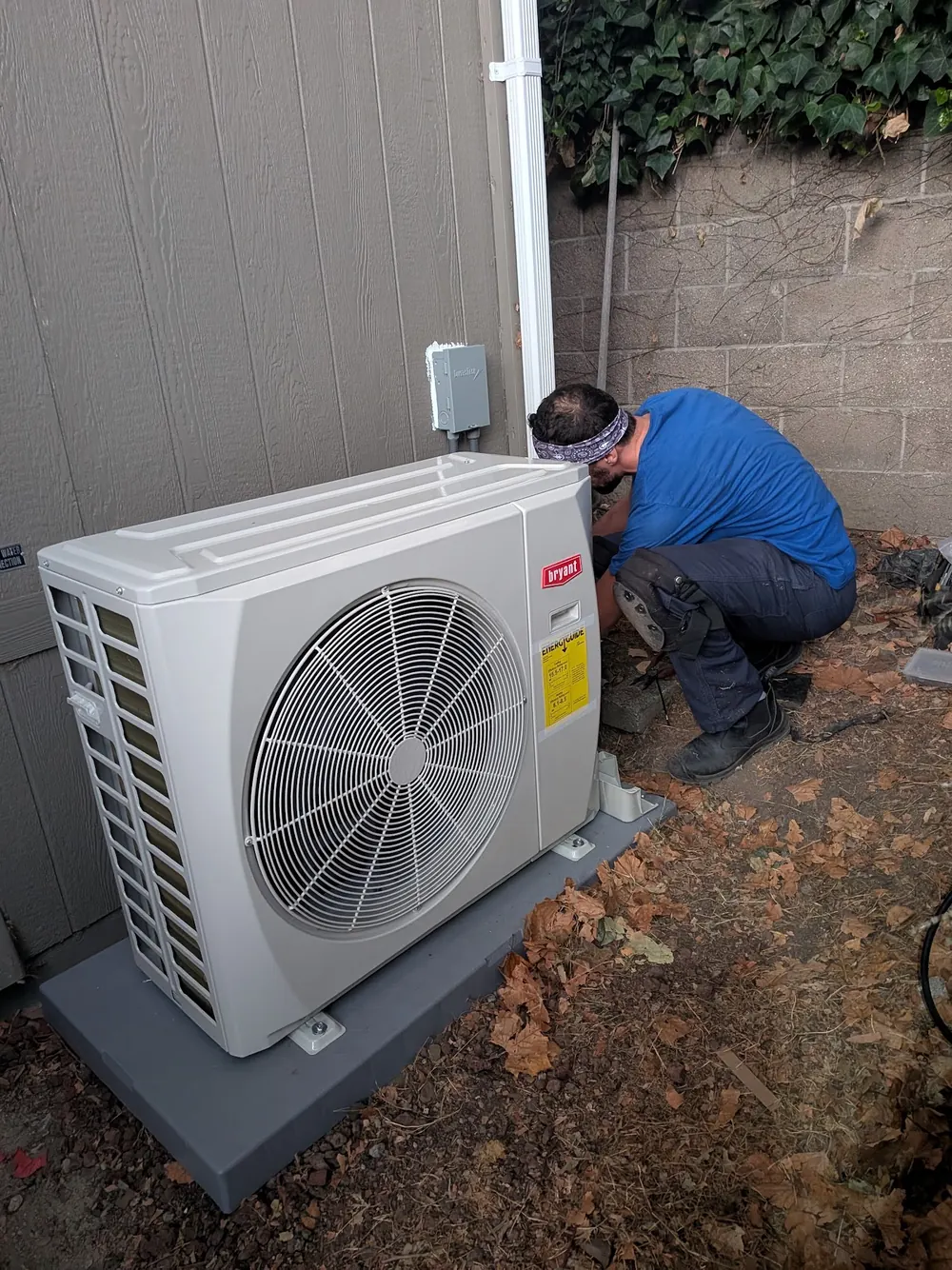 A Velair technician installing a ductless outdoor unit.
